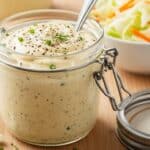 Easy coleslaw dressing in a jar with fresh cabbage